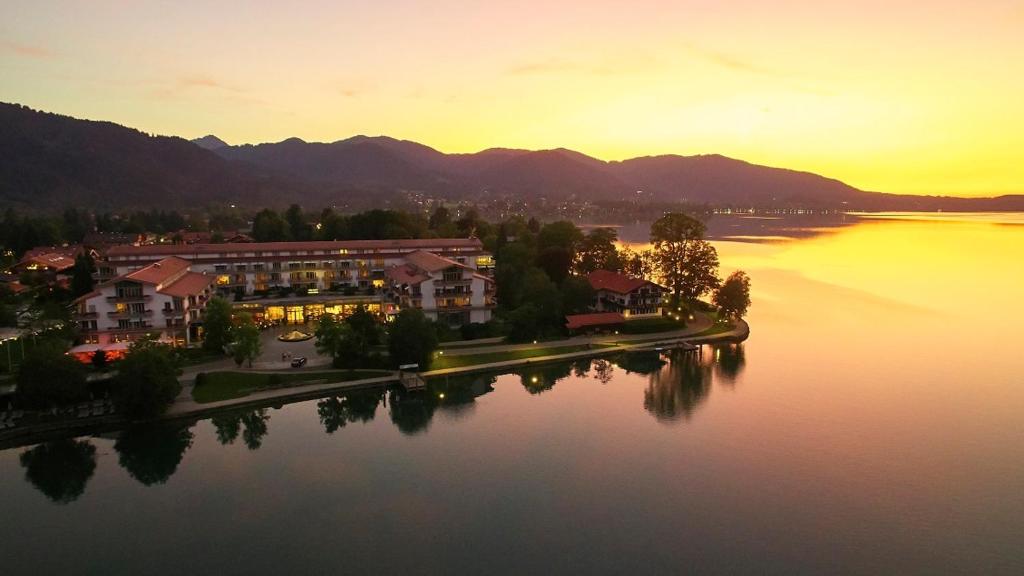 Luxury hotel on the shore of Lake Tegernsee with mountains in the background
